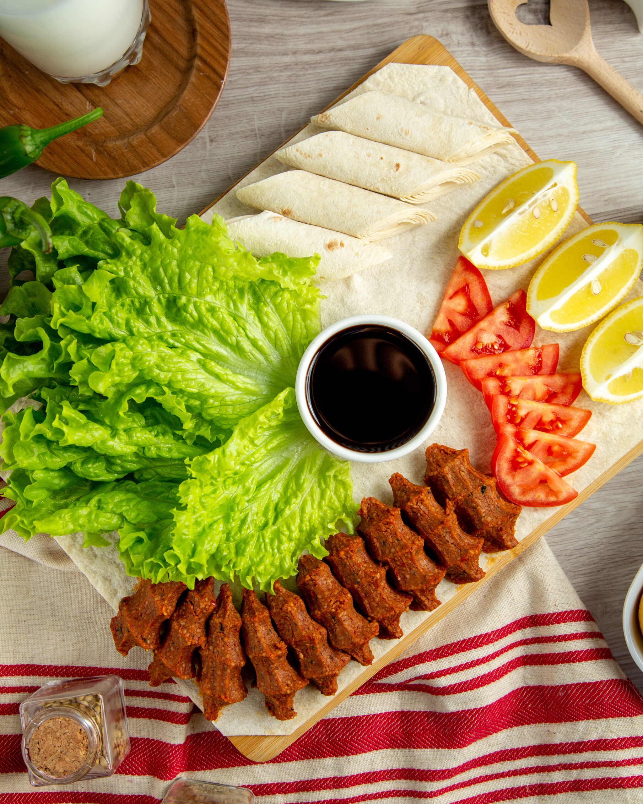 Turkish kofte meat lettuce tomato lemon top view scaled